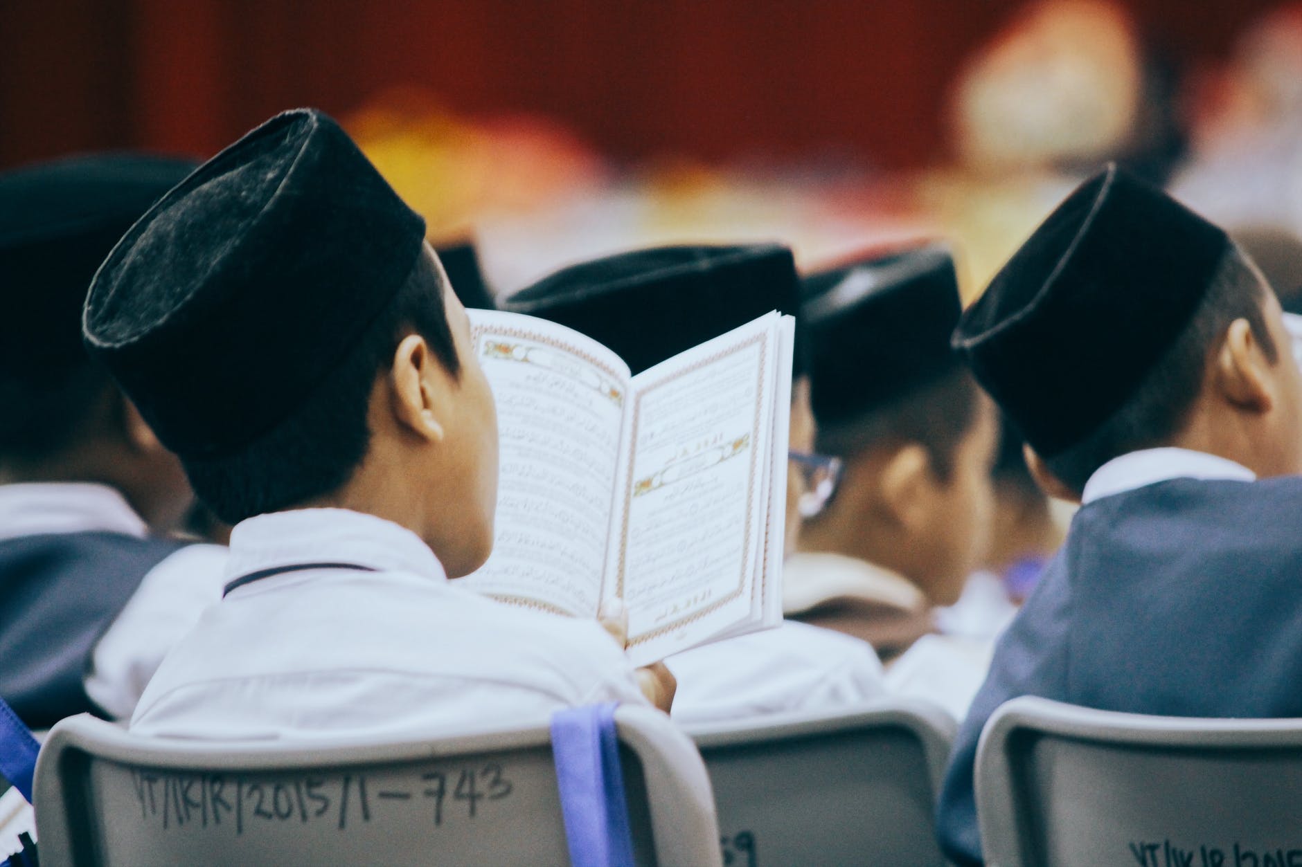 people sitting on chair reading books
